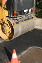 detail of an heavy road roller with one traffic cone Royalty Free Stock Photo