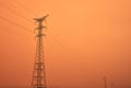 High voltage power lines between the haze of the sahara desert Royalty Free Stock Photo