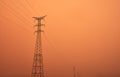 High voltage power lines between the haze of the sahara desert Royalty Free Stock Photo