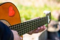 Detail Hippy man playing guitar outdoors on the grass Royalty Free Stock Photo