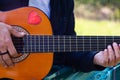 Detail Hippy man playing guitar outdoors on the grass Royalty Free Stock Photo