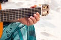 Detail Hippy man playing guitar outdoors on the sand Royalty Free Stock Photo