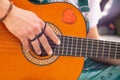Detail Hippy man playing guitar outdoors on the sand Royalty Free Stock Photo