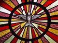 Detail of Holy Spirit stained glass in church door Royalty Free Stock Photo