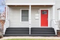 Detail of a home\'s front porch and red front door. Royalty Free Stock Photo