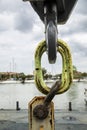 Detail of a hook attached to a construction crane in a port in Italy. Cloudy sky Royalty Free Stock Photo