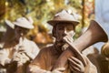 Detail of a horn player in traditional South Tyrol clothes. Carved wooden statue Royalty Free Stock Photo