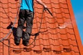 Worker cleaning metal roof with high pressure water