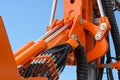 Detail of hydraulic bulldozer piston excavator arm against blue sky Royalty Free Stock Photo