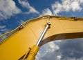 Detail of hydraulic bulldozer piston excavator arm on sky backg Royalty Free Stock Photo