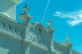 Detail image of church architecture in late afternoon shade with white cement or stucco exterior and visible sun streaks Royalty Free Stock Photo