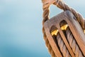 Macro of wooden pulley wit nautical ropes of traditional sailboat Royalty Free Stock Photo