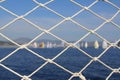 Detail image of wooden pulley with ropes of an classical sailing yacht. ocean and sailing boats in the blurry background