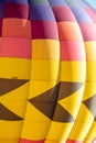 an inflating hot air balloon with yellow, purple, and orange color panels. Royalty Free Stock Photo