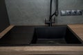 Detail of the interior of a luxury kitchen, a black rectangular sink and a black faucet Royalty Free Stock Photo