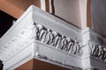 Detail of intricate corner crown molding intricate angle casting detail. Handmade finish of the white corner of the wall inside