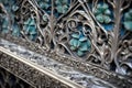 detail of an intricate metal filigree, bound to the stone of a cathedral