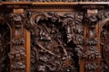 detail of intricate wood carvings on a victorian era armoire