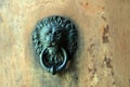 Detail of iron lion head door knocker on old door