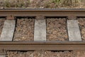 Detail iron rails of the train between rocks