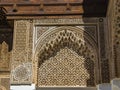 Detail of islamic building. It is an old architecture in the middle of the Moroccan city. There are white walls with wooden carved