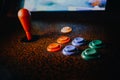 Detail on a joystick and button controls of a vintage arcade video game in a dark room