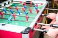 Detail of kid`s hands playing the foosball table match. Soccer game, friends recreation Royalty Free Stock Photo