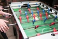 Detail of kid`s hands playing the foosball table match. Soccer game, friends recreation Royalty Free Stock Photo