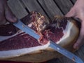 Detail of knife slicing spanish ham