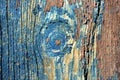 Detail from knothole on old painted door. Royalty Free Stock Photo