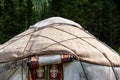 Detail of Kyrgyz yurt door and roof on grass in middle of the mountains. Yurts are traditional national buildings of local