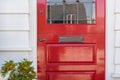 Detail of lacquered red front door to a home Royalty Free Stock Photo