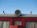 Detail of lamp at roof of red train wagon