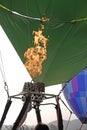 Inflames fire and inflates the balloon.Detail of a large hot air balloon being inflated for its initial flight.