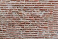 Detail of a large section of a red, brick wall worn down by time Royalty Free Stock Photo