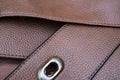 Detail of a leather bag close-up. Leather metal buckle on bag