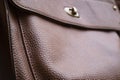 Detail of a leather bag close-up. Leather metal buckle on bag