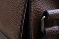 Detail of a leather bag close-up. Leather metal buckle on bag