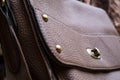 Detail of a leather bag close-up. Leather metal buckle on bag