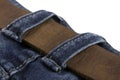 Detail of leather belt on a blue jeans isolated on white background Royalty Free Stock Photo