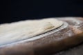 Detail of a leavened disk of a real Italian pizza on black background
