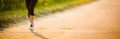 Detail of legs of a female runner on road Royalty Free Stock Photo