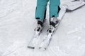 Detail of legs of young woman skier in ski boots close-up. Winter sport concept, leisure outdoor lifestyle