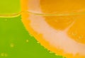 Detail of a lemon in a glass on green background Royalty Free Stock Photo