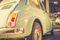 Light blue vintage fiat 500 parked in the street