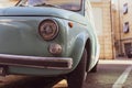 Light blue vintage fiat 500 parked in the street