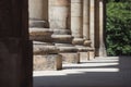 detail of light and shadow on a stylobate of a column or pillar in a row with others next to each other in a corridor Royalty Free Stock Photo