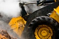 Detail loader and piles of steaming mulch Royalty Free Stock Photo