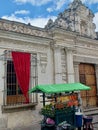 Detail of local vendor wagon in front of a wooden entrance of an old house close to San Jose Cathedral and San Carlos university.