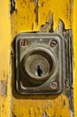 Detail of the lock of an old wooden door painted yellow Royalty Free Stock Photo